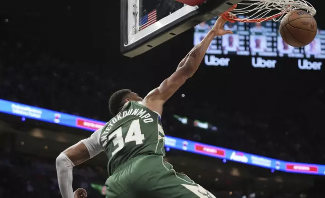 Milwaukee Bucks forward Giannis Antetokounmpo (34) dunks during the first half of an NBA basketball game against the Miami Heat, Saturday, April 5, 2025, in Miami. (AP Photo/Lynne Sladky)