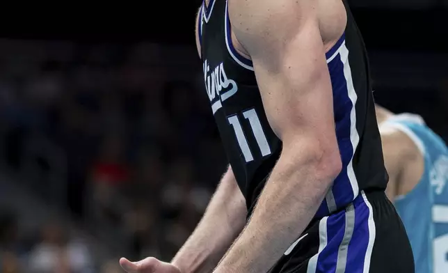 Sacramento Kings forward Domantas Sabonis reacts during the second half of an NBA basketball game against the Charlotte Hornets, Friday, April 4, 2025, in Charlotte, N.C. (AP Photo/Jacob Kupferman)