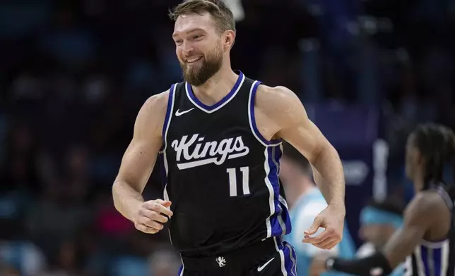 Sacramento Kings forward Domantas Sabonis (11) reacts during the first half of an NBA basketball game against the Charlotte Hornets, Friday, April 4, 2025, in Charlotte, N.C. (AP Photo/Jacob Kupferman)
