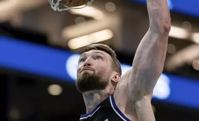 Sacramento Kings forward Domantas Sabonis dunks during the second half of an NBA basketball game against the Charlotte Hornets, Friday, April 4, 2025, in Charlotte, N.C. (AP Photo/Jacob Kupferman)