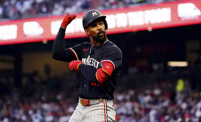 Minnesota Twins' Byron Buxton celebrates after hitting a triple against the Atlanta Braves during the third inning of a baseball game Saturday, April 19, 2025, in Atlanta. (AP Photo/John David Mercer)