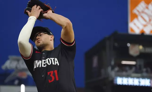 Minnesota Twins first base Jonah Bride (31) catches a pop fly ball against the Atlanta Braves during the third inning in a baseball game at Truist Park, Saturday, April 19, 2025, in Atlanta. (AP Photo/ John David Mercer)