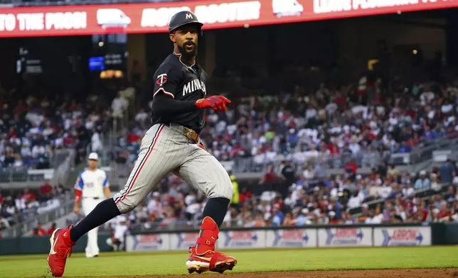 Minnesota Twins outfielder Byron Buxton (25) runs to third base on a triple against the Atlanta Braves during the third inning in a baseball game at Truist Park, Saturday, April 19, 2025, in Atlanta. (AP Photo/ John David Mercer)