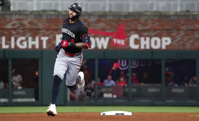 Minnesota Twins shortstop Carlos Correa (4) rounds second base on his solo homerun against the Atlanta Braves during the fourth inning in a baseball game at Truist Park, Saturday, April 19, 2025, in Atlanta. (AP Photo/ John David Mercer)