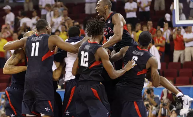 FILE - Team USA, with Kobe Bryant at top right, celebrates following their win over Spain in their men's gold medal basketball game at the Beijing 2008 Olympics in Beijing, Sunday, Aug. 24, 2008. (AP Photo/Eric Gay, File)