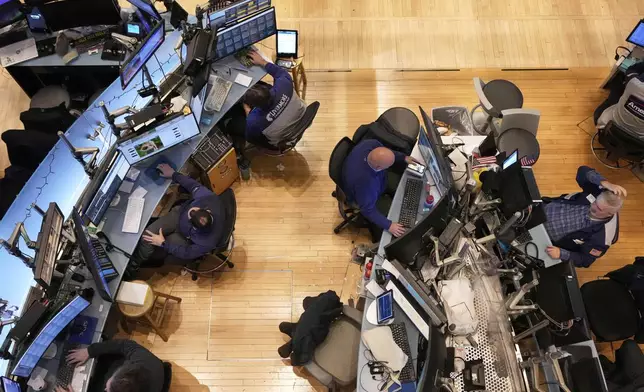 Traders work on the floor of the New York Stock Exchange, Thursday, April 10, 2025. (AP Photo/Richard Drew)