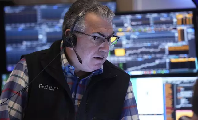 Trader John Bishop works on the floor of the New York Stock Exchange, Thursday, April 10, 2025. (AP Photo/Richard Drew)