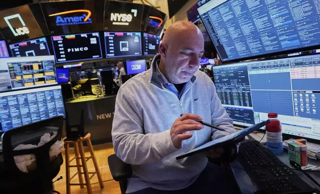 Vincent Napolitano works on the floor of the New York Stock Exchange, Friday, April 11, 2025. (AP Photo/Richard Drew)