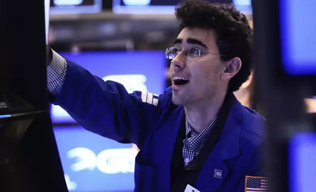 Specialist Alexander Weitzman works at his post on the floor of the New York Stock Exchange, Friday, April 11, 2025. (AP Photo/Richard Drew)