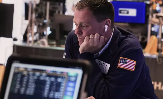 Trader Matt Chellock works on the floor of the New York Stock Exchange, Thursday, April 10, 2025, New York. (AP Photo/Richard Drew)