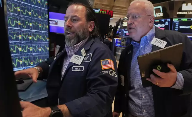 Specialist Michael Pistillo, left, and trader Thomas Ferrigno work on the floor of the New York Stock Exchange, Thursday, April 10, 2025. (AP Photo/Richard Drew)