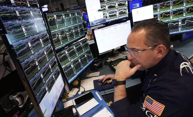 Specialist Anthony Matesic works at his post on the floor of the New York Stock Exchange, Friday, April 11, 2025. (AP Photo/Richard Drew)
