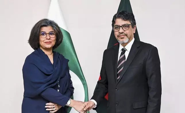 Bangladesh Foreign Secretary Md. Jashim Uddin, right, shakes hands with Pakistan Foreign Secretary Amna Baloch as they pose for a photograph during their bilateral meeting in Dhaka, Thursday, April 17, 2025. (Bangladesh Ministry of Foreign Affairs via AP)