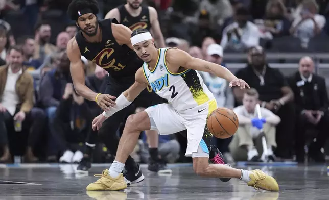 Indiana Pacers guard Andrew Nembhard (2) looses the ball in front of Cleveland Cavaliers center Jarrett Allen (31) during the first half of an NBA basketball game in Indianapolis, Thursday, April 10, 2025. (AP Photo/Michael Conroy)