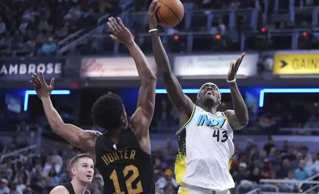 Indiana Pacers forward Pascal Siakam (43) shoots over Cleveland Cavaliers forward De'Andre Hunter (12) during the second half of an NBA basketball game in Indianapolis, Thursday, April 10, 2025. (AP Photo/Michael Conroy)