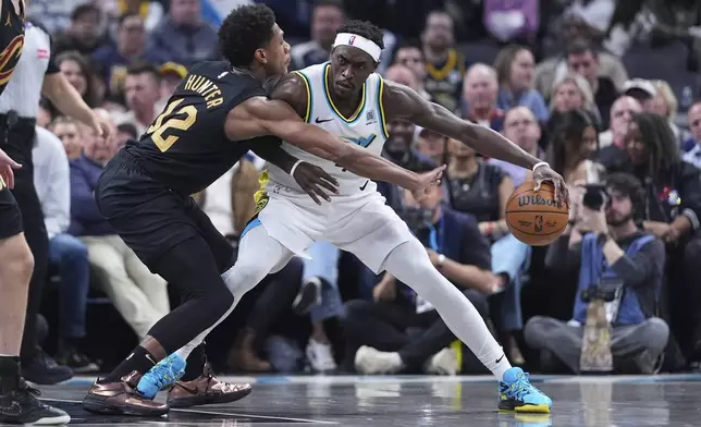 Indiana Pacers forward Pascal Siakam (43) drives on Cleveland Cavaliers forward De'Andre Hunter (12) during the first half of an NBA basketball game in Indianapolis, Thursday, April 10, 2025. (AP Photo/Michael Conroy)