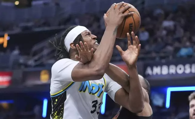 Indiana Pacers center Myles Turner (33) is fouled by Cleveland Cavaliers forward Isaac Okoro (35) during the second half of an NBA basketball game in Indianapolis, Thursday, April 10, 2025. (AP Photo/Michael Conroy)