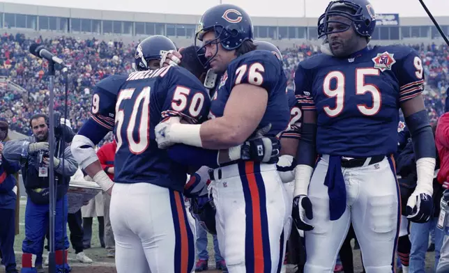 FILE - Chicago Bears nine-time Pro Bowler Mike Singletary (50) gets a bear hug from teammate Steve McMichael (76) prior to an NFL football game against the Pittsburgh Steelers in Chicago, Dec. 13, 1992. (AP Photo/David Boe, File)