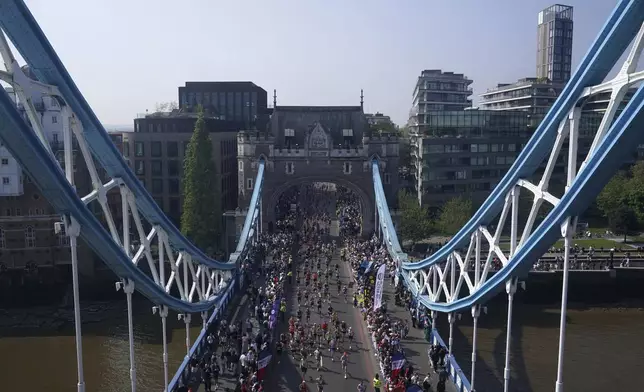 The masses cross Tower Bridge during the TCS London Marathon, Sunday April 27, 2025. (Jonathan Brady/PA via AP)