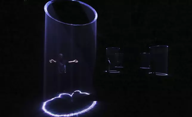 People visit "Making the Invisible Visible", a Google Design Studio installation, as part of the Design Fair exhibition, in Milan, Italy, Monday, April 7, 2025. (AP Photo/Antonio Calanni)