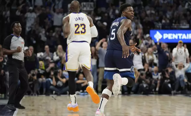 Minnesota Timberwolves guard Anthony Edwards (5) celebrates next to Los Angeles Lakers forward LeBron James (23) after making a 3-point shot during the first half of Game 4 of an NBA basketball first-round playoff series, Sunday, April 27, 2025, in Minneapolis. (AP Photo/Abbie Parr)