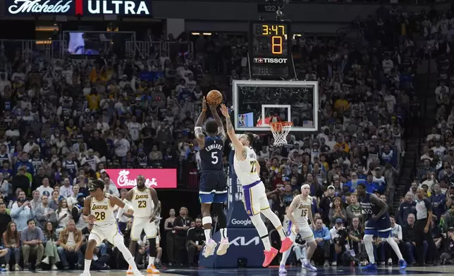 Minnesota Timberwolves guard Anthony Edwards (5) shoots over Los Angeles Lakers guard Luka Doncic (77) during the second half of Game 4 of an NBA basketball first-round playoff series, Sunday, April 27, 2025, in Minneapolis. (AP Photo/Abbie Parr)