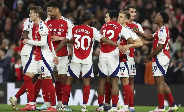 Arsenal's Leandro Trossard celebrates with teammates after scoring his sides second goal during the English Premier League soccer match between Arsenal and Crystal Palace at Emirates stadium in London, Wednesday, April 23, 2025. (AP Photo/Ian Walton)