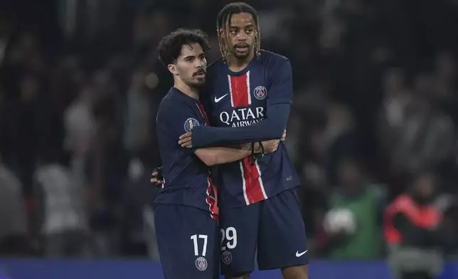 PSG's Vitinha, left, and Bradley Barcola stand. dejected after the League One soccer match between PSG and Nice in Paris Friday, April 25, 2025. (AP Photo/Thibault Camus)