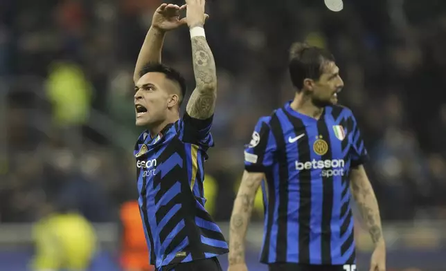 Inter Milan players celebrate at the end of the Champions League quarterfinal second leg soccer match between Inter Milan and Bayern Munich at the San Siro stadium in Milan, Italy, Wednesday, April 16, 2025. (AP Photo/Luca Bruno)
