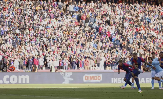 Barcelona's Raphinha shoots a penalty kick to score during a Spanish La Liga soccer match between Barcelona and Celta de Vigo at the Lluis Companys Olympic stadium in Barcelona, Spain, Saturday, April 19, 2025. (AP Photo/Joan Monfort)