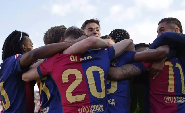 Barcelona players celebrate their victory at the Spanish La Liga soccer match between Barcelona and Celta de Vigo at the Lluis Companys Olympic stadium in Barcelona, Spain, Saturday, April 19, 2025. (AP Photo/Joan Monfort)
