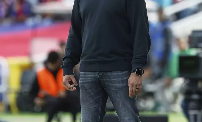 Barcelona's head coach Hansi Flick reacts during a Spanish La Liga soccer match between Barcelona and Celta de Vigo at the Lluis Companys Olympic stadium in Barcelona, Spain, Saturday, April 19, 2025. (AP Photo/Joan Monfort)