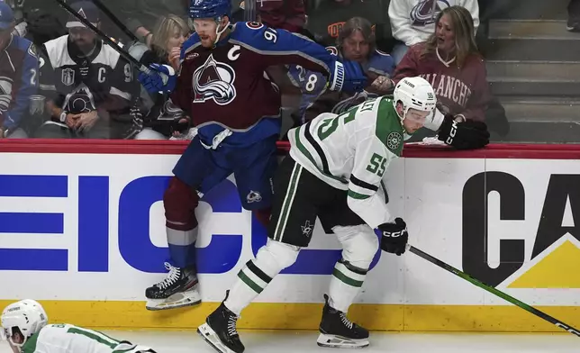 Dallas Stars defenseman Thomas Harley, right, checks Colorado Avalanche left wing Gabriel Landeskog in the first period of Game 3 of an NHL hockey first-round playoff series Wednesday, April 23, 2025, in Denver. (AP Photo/David Zalubowski)