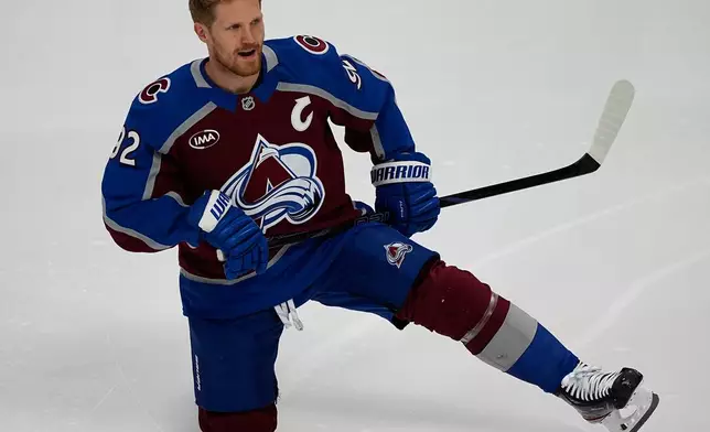 Colorado Avalanche left wing Gabriel Landeskog stretches before the first period of Game 3 of an NHL first-round hockey playoff series against the Dallas Stars Wednesday, April 23, 2025, in Denver. (AP Photo/David Zalubowski)