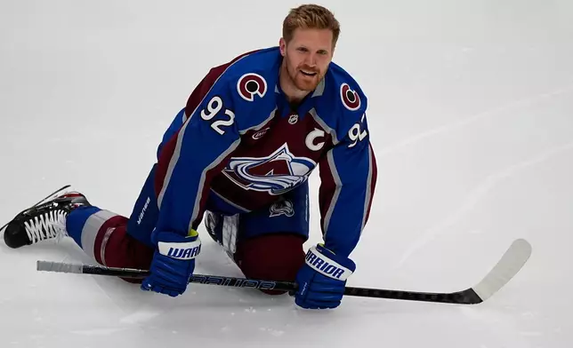 Colorado Avalanche left wing Gabriel Landeskog stretches before the first period of Game 3 of an NHL first-round hockey playoff series against the Dallas Stars Wednesday, April 23, 2025, in Denver. (AP Photo/David Zalubowski)