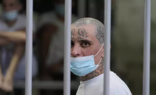 A prisoner looks out from his cell as Homeland Security Secretary Kristi Noem tours the Terrorist Confinement Center in Tecoluca, El Salvador, Wednesday, March 26, 2025. (AP Photo/Alex Brandon)