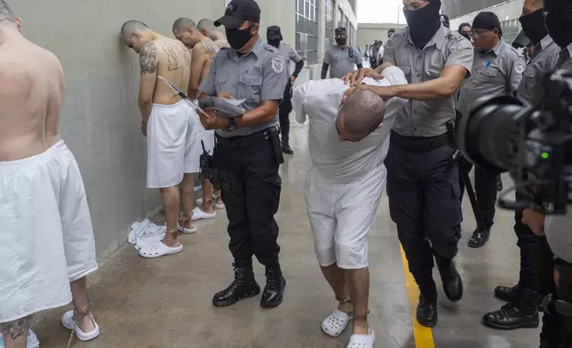A prisoner is moved as Homeland Security Secretary Kristi Noem tours of the Terrorist Confinement Center in Tecoluca, El Salvador, Wednesday, March 26, 2025. (AP Photo/Alex Brandon)