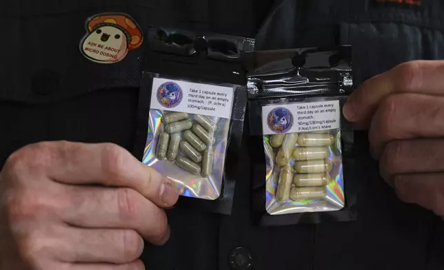 Marine Corps combat veteran Matt Metzger, who grows his own mushrooms for microdosing psilocybin, displays prepared doses in packets Wednesday, March 26, 2025, in Olympia, Wash. (AP Photo/Lindsey Wasson)