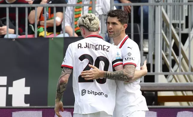 AC Milan's Christian Pulisic, right, celebrates scoring his side's opening goal during the Serie A soccer match between Venezia and AC Milan at the Pier Luigi Penzo Stadium, in Venice, Italy, Sunday, April 27, 2025. (Paola Garbuio/LaPresse via AP)