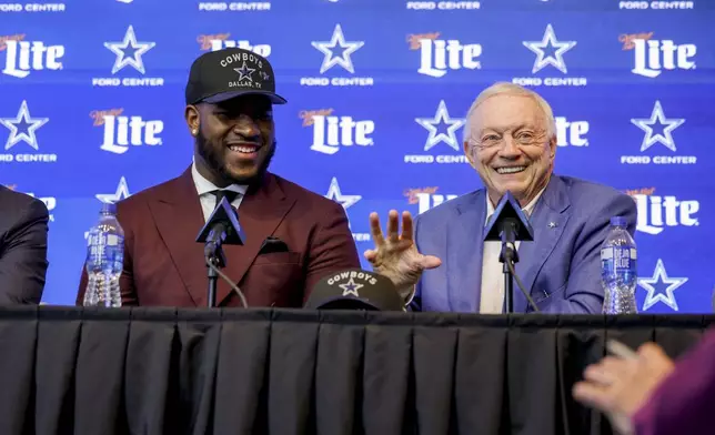 Dallas Cowboys first-round NFL football draft pick Tyler Booker, left, and team owner Jerry Jones, right, speak during a news conference in Frisco, Texas, Friday, April 25, 2025. (AP Photo/Gareth Patterson)