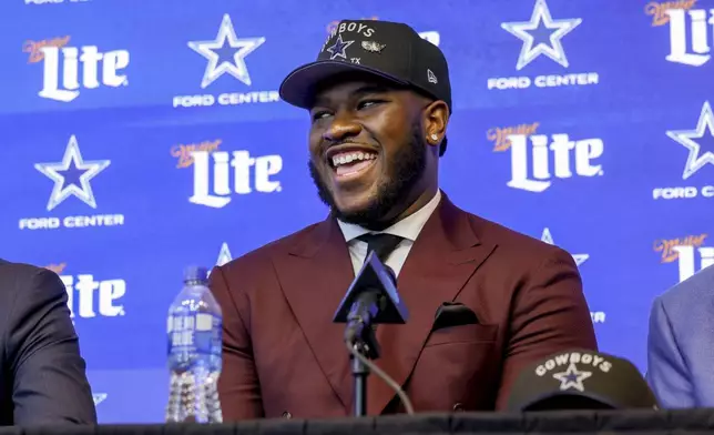 Dallas Cowboys first-round NFL football draft pick Tyler Booker laughs during a news conference in Frisco, Texas, Friday, April 25, 2025. (AP Photo/Gareth Patterson)