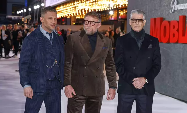 Tom Hardy, from left, director Guy Ritchie and Pierce Brosnan pose for photographers upon arrival at the premiere of 'MobLand' on Thursday, March 27, 2025, in London. (Photo by Millie Turner/Invision/AP)