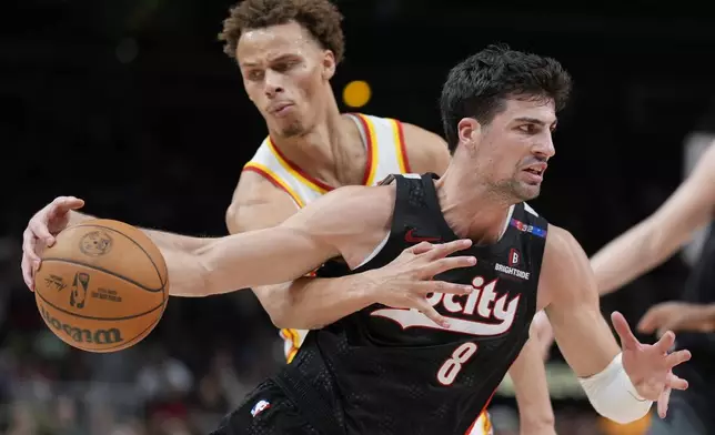 Portland Trail Blazers forward Deni Avdija (8) moves against Atlanta Hawks guard Dyson Daniels (5) during the second half of an NBA basketball game, Tuesday, April 1, 2025, in Atlanta. (AP Photo/Mike Stewart)