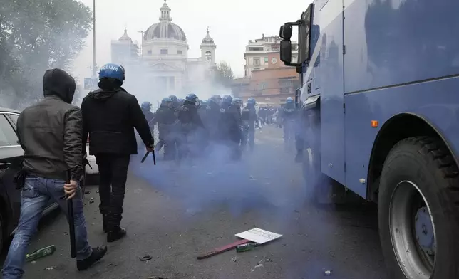 Lazio fans riot with police ahead of the Italian Serie A soccer match between Lazio and Roma at Rome's Olympic stadium, Sunday, April 13, 2025. (AP Photo/Gregorio Borgia)