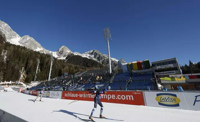 An athlete participates in a Biathlon World Cup race at the Biathlon Arena in Anterselva where the biathlon discipline will take place during the Milan Cortina 2026 Winter Olympics, in northern Italy, Friday, Jan. 24, 2025. (AP Photo/Alessandro Trovati)