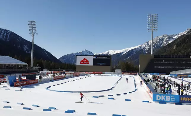 Athletes compete during a Biathlon World Cup event at the Anterselva Biathlon Arena, venue for the biathlon discipline at the Milan Cortina 2026 Winter Olympics, in Anterselva, northern Italy, Saturday, Jan. 25, 2025. (AP Photo/Alessandro Trovati)