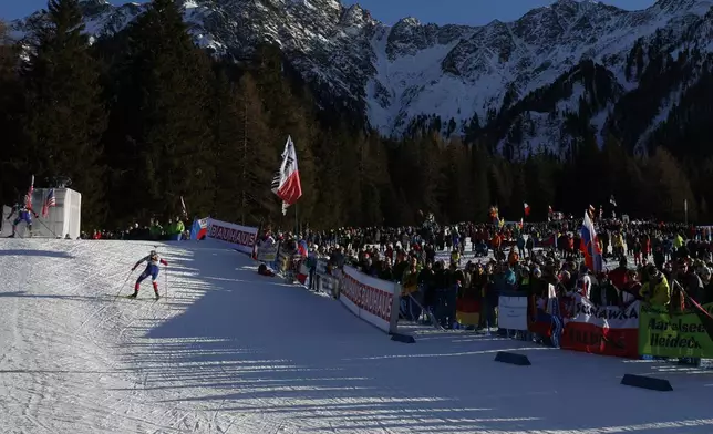 Spectators watch the Biathlon men's World Cup 10km sprint race, in Anterselva, Italy, Friday Jan. 24, 2025. (AP Photo/Alessandro Trovati)
