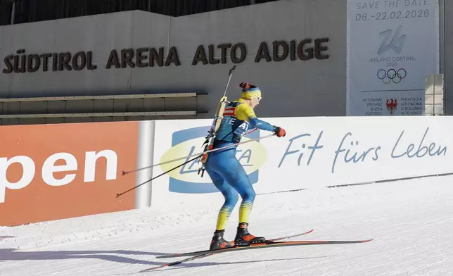 An athlete participates in a Biathlon World Cup race at the Biathlon Arena in Anterselva where the biathlon discipline will take place during the Milan Cortina 2026 Winter Olympics, in northern Italy, Friday, Jan. 24, 2025. (AP Photo/Alessandro Trovati)