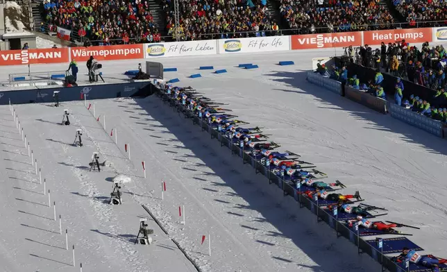Athletes are seen at the shooting range during a Biathlon World Cup event at the Anterselva Biathlon Arena, venue for the biathlon discipline at the Milan Cortina 2026 Winter Olympics, in Anterselva, northern Italy, Saturday, Jan. 25, 2025. (AP Photo/Alessandro Trovati)