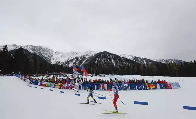 Sweden's Anna-Karin Heijdenberg leads Poland's Joanna Jakiela, right, during a Biathlon women's World Cup 7.5km sprint race, in Anterselva, Italy, Thursday Jan. 23, 2025. (AP Photo/Alessandro Trovati)